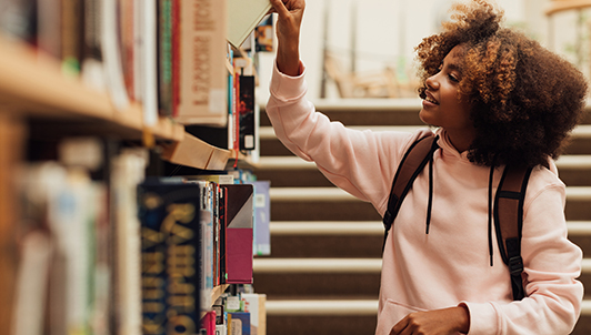 Girl selecting a library book